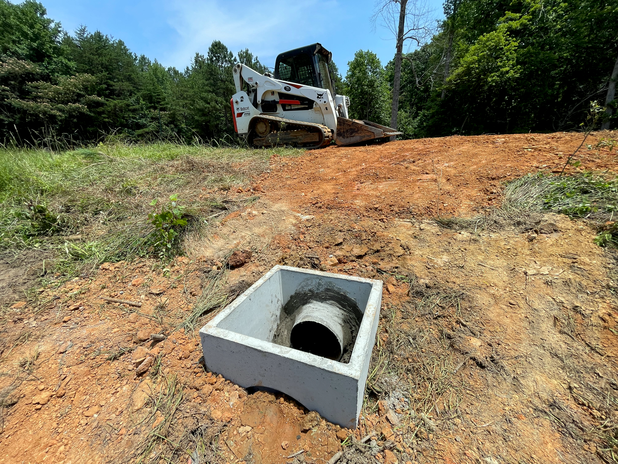 Picture of a concrete overflow box with a 12-inch plastic pipe