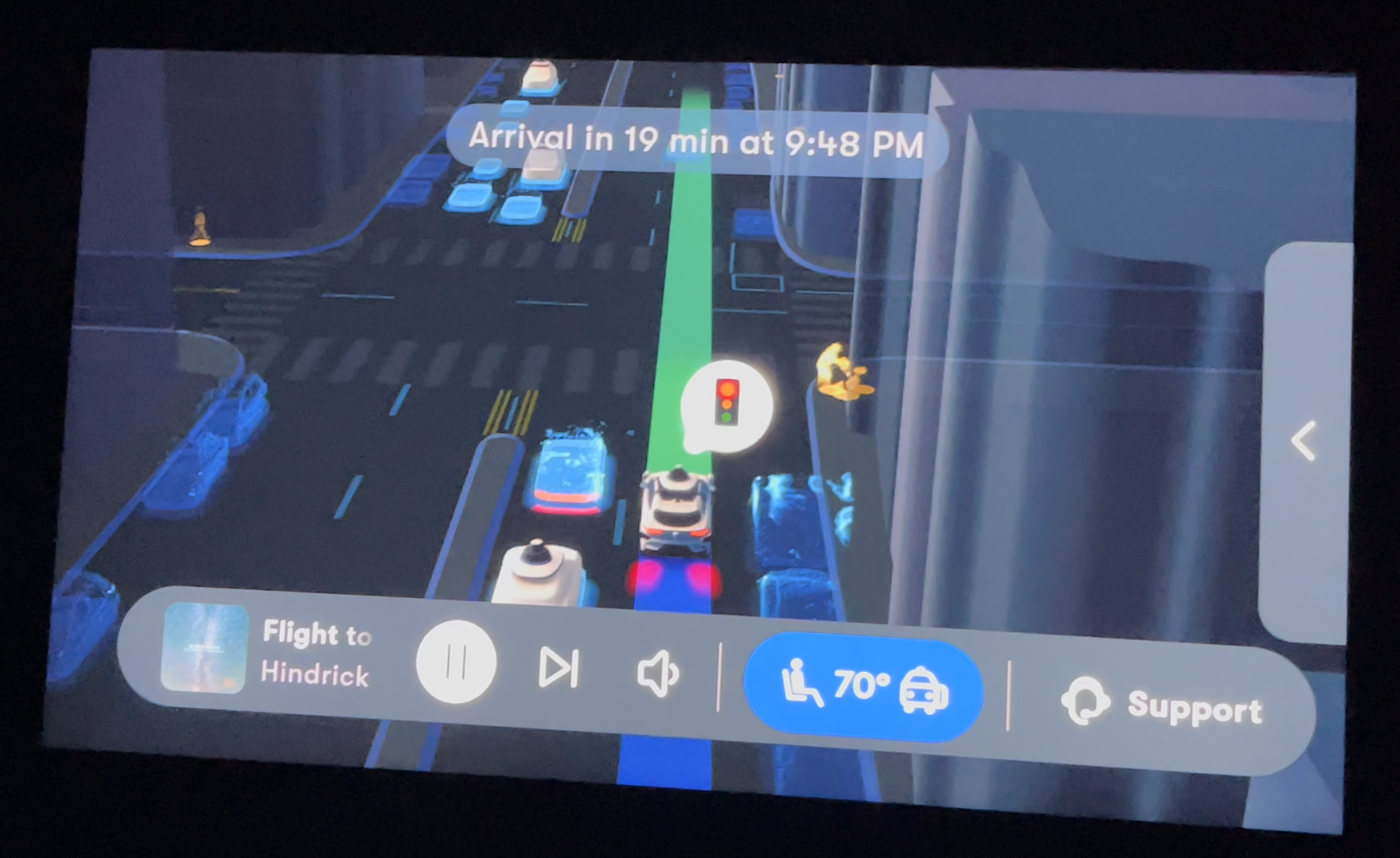 A Waymo screen showing cars, a stoplight, and people