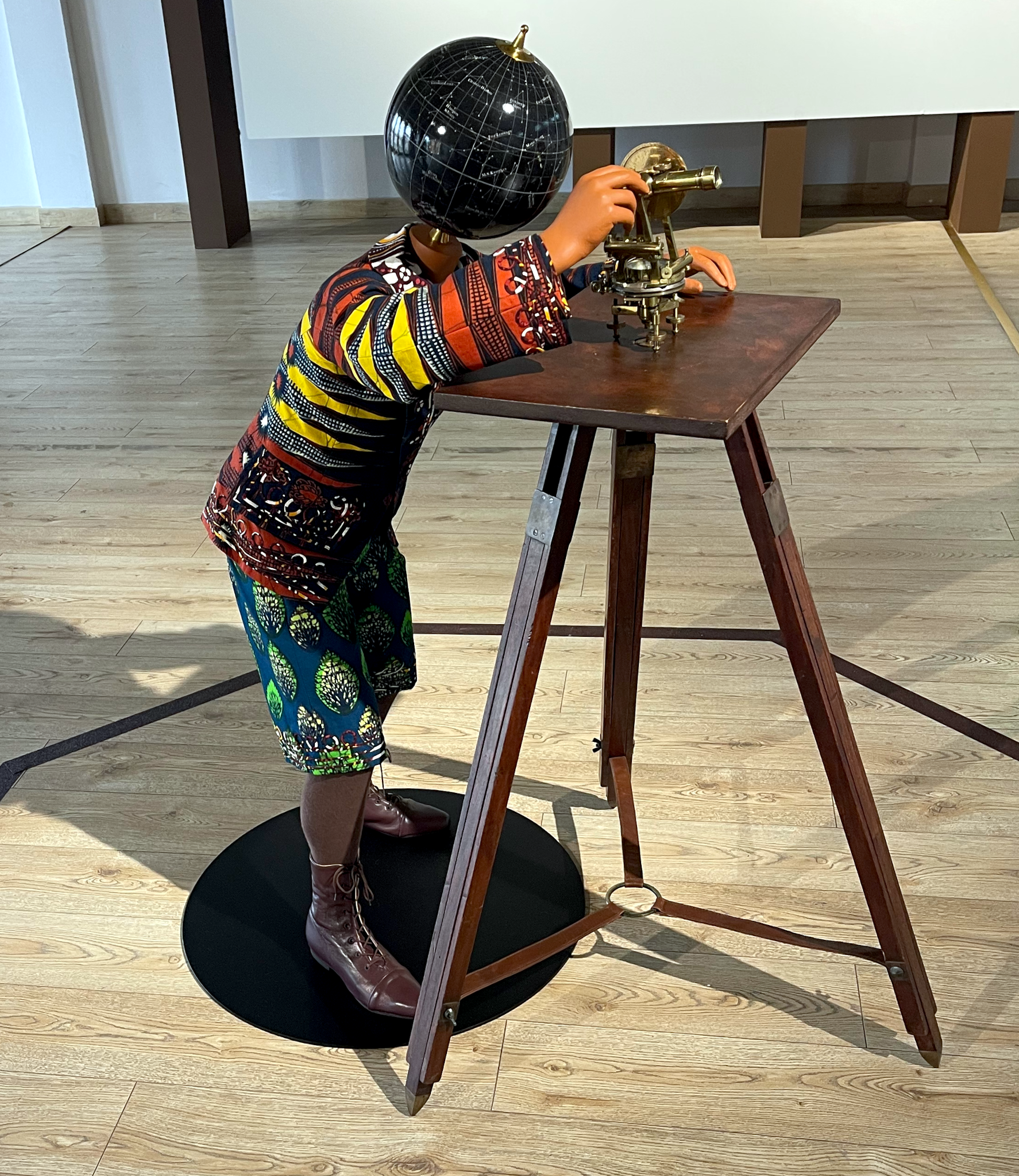Art of a small child with a globe for a head